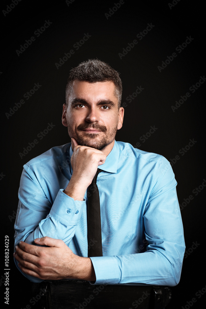 Handsome businessman on black background Handsome businessman on black background