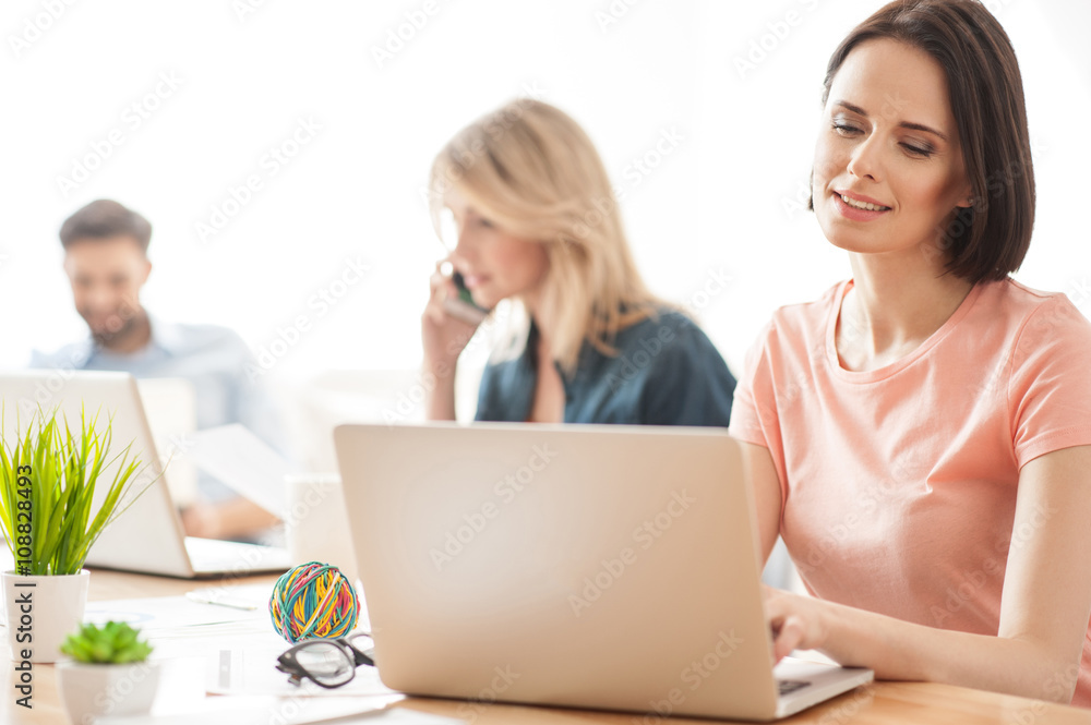 Skillful young coworkers are using their computers Skillful young coworkers are using their computers