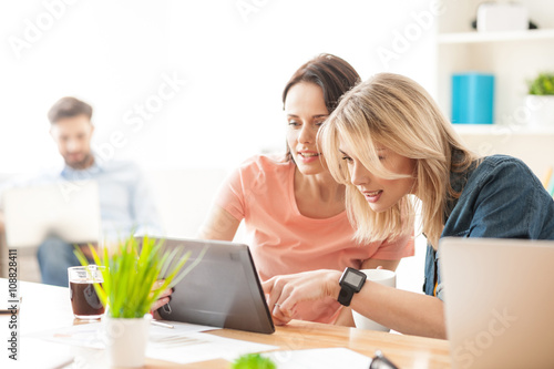 Attractive two female colleagues are making a break
