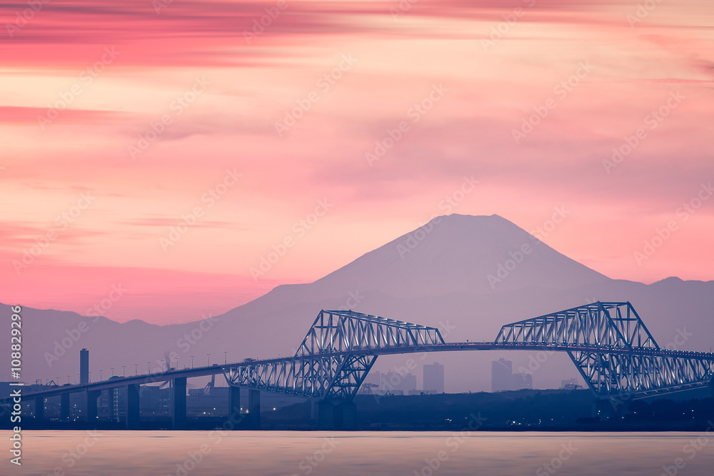 Tokyo bay at sunset with Tokyo gate bridge and Mountain Fuji .