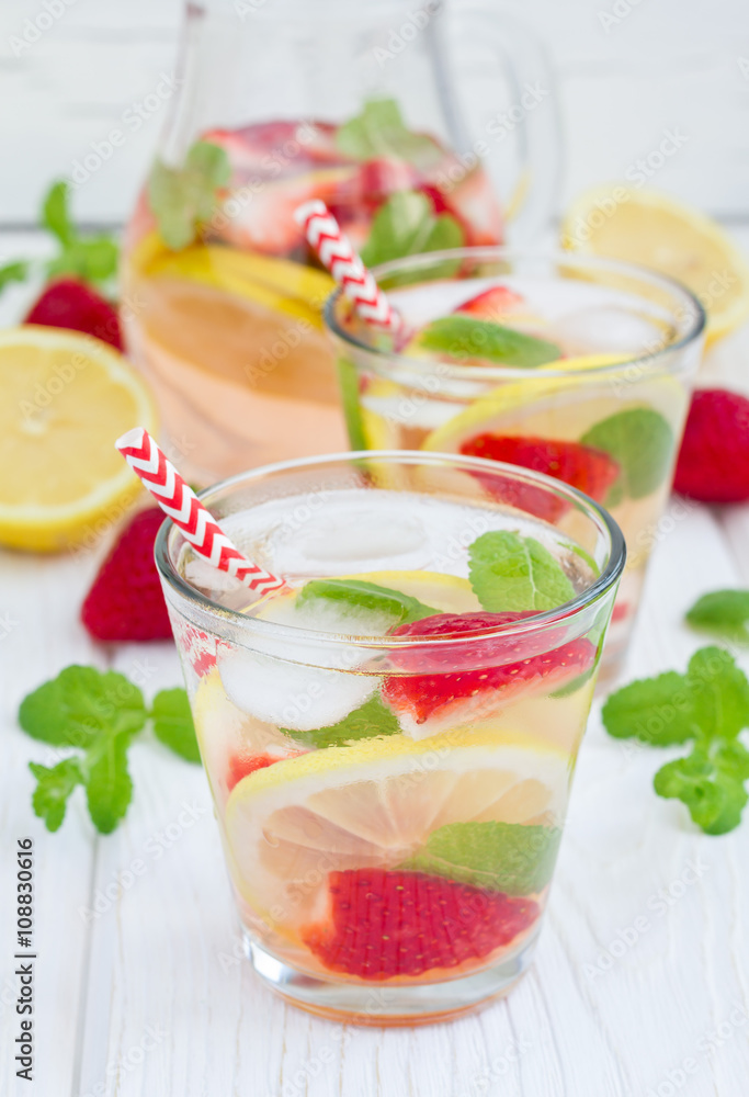 Strawberry mint homemade lemonade on white wooden table Strawberry mint homemade lemonade on white wooden table