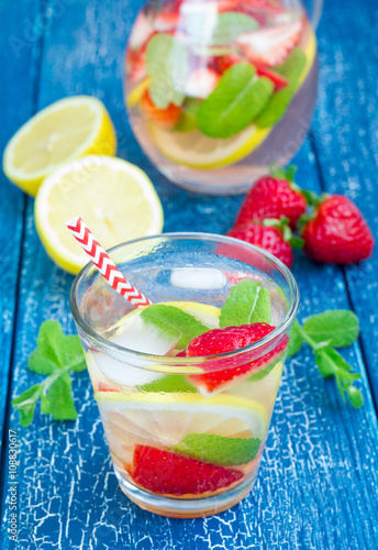 Strawberry mint homemade lemonade on blue wooden table