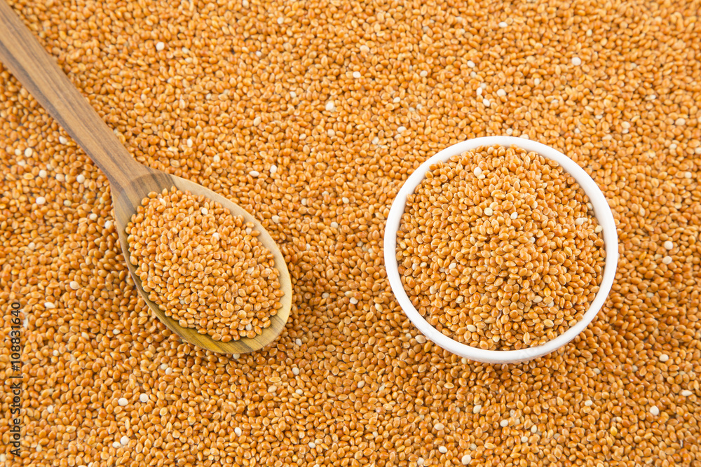 Millet cereal grains with bowl and wooden spoon. Stock Photo Adobe Stock