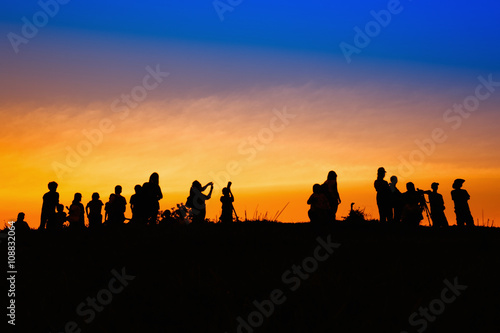 Silhouette tourists and photographers with beautiful sunrise on