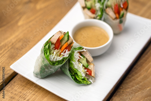 Vietnamese Spring Rolls Appetizers. These are great as an healthy appetizer or lunch. Served with peanut butter sauce. photo