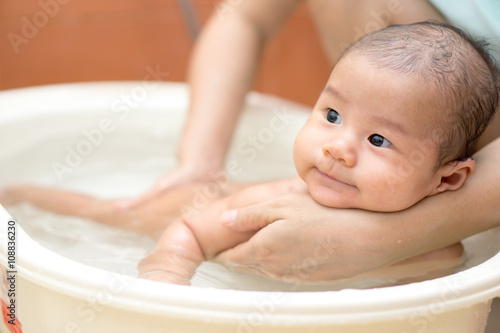 Asian baby bathing