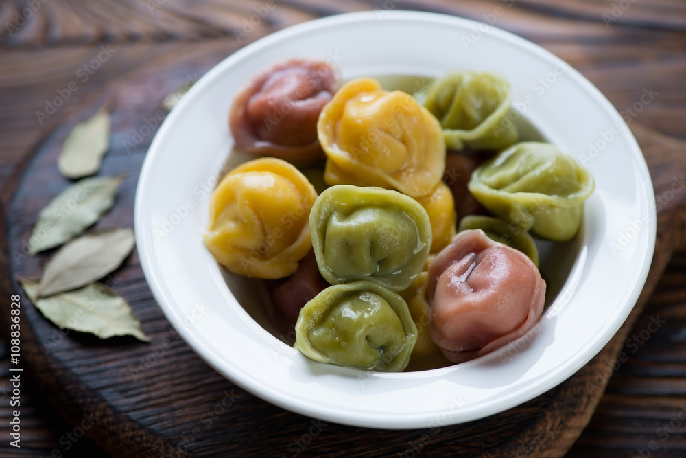 Close-up of a glass plate with colored meat dumplings or pelmeni Close-up of a glass plate with colored meat dumplings or pelmeni