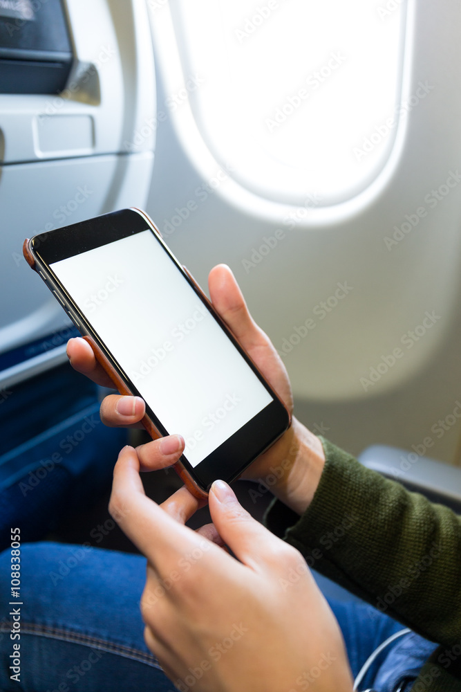 Holding smart phone in airplane Holding smart phone in airplane