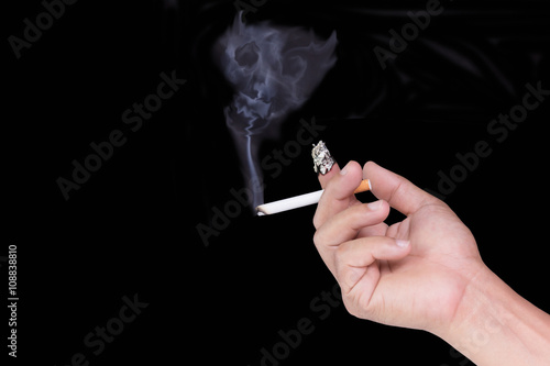 Hand hold cigarette and finger burn on black background