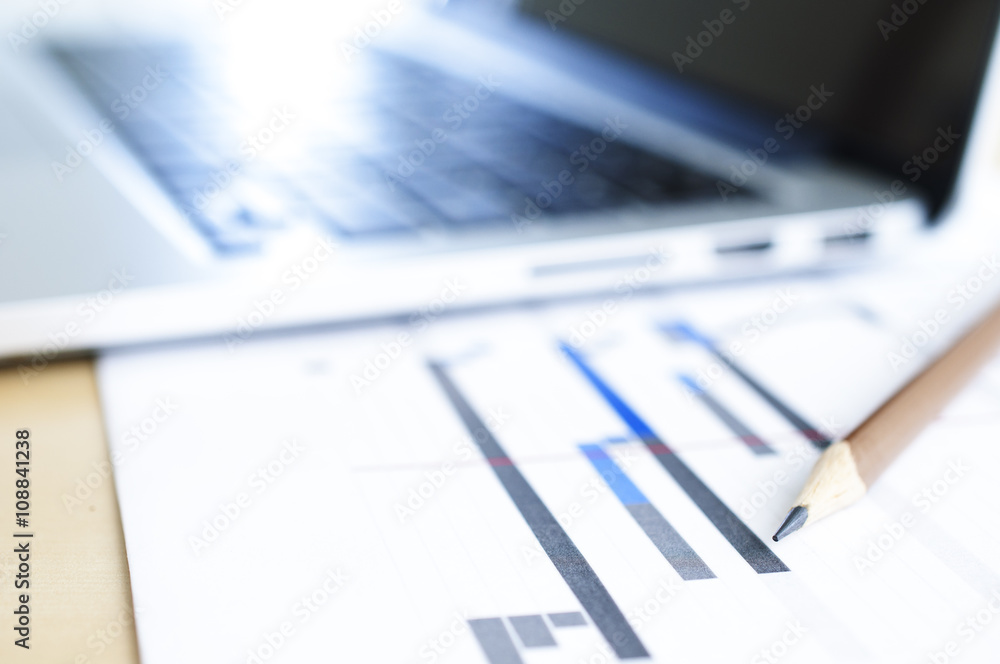 Selective focus on Pencil with schedule plan and blur laptop background Selective focus on Pencil with schedule plan and blur laptop background