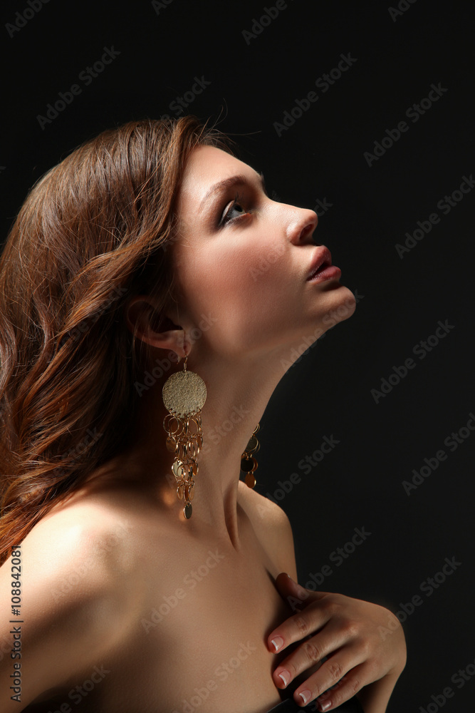 Fototapeta Portrait of beautiful young woman . Isolated on dark background