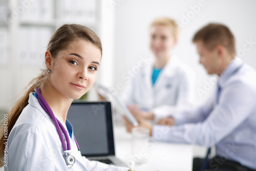 Medical team sitting at the table in modern hospital