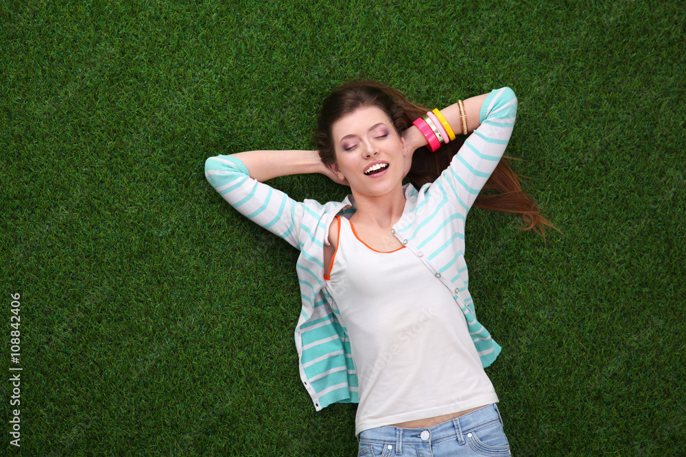 Top view of beautiful young woman holding hands behind head Top view of beautiful young woman holding hands behind head