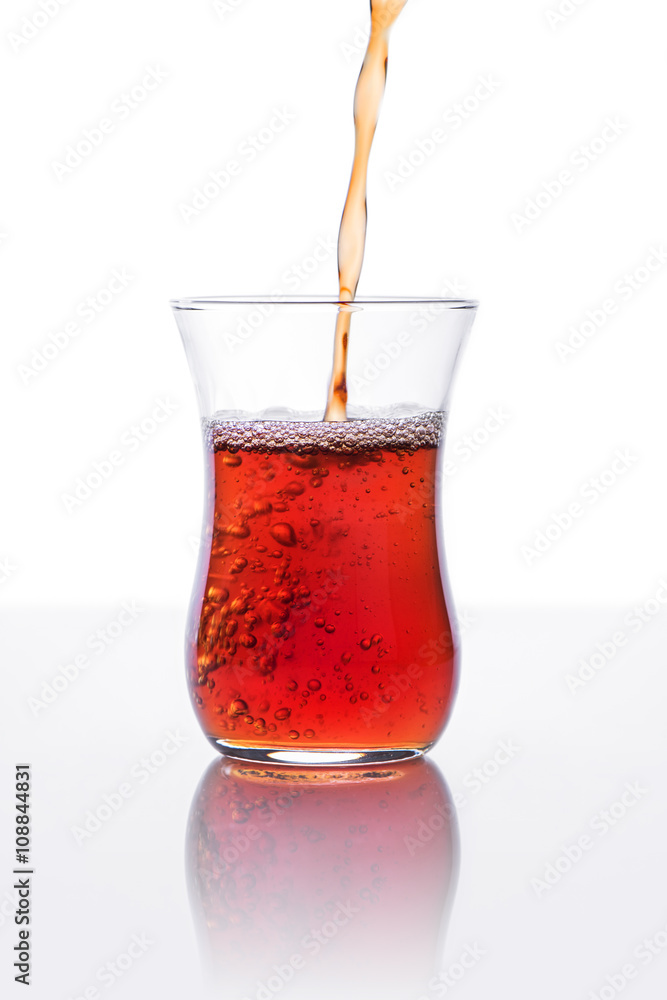Pouring red tea in a glass Pouring red tea in a glass
