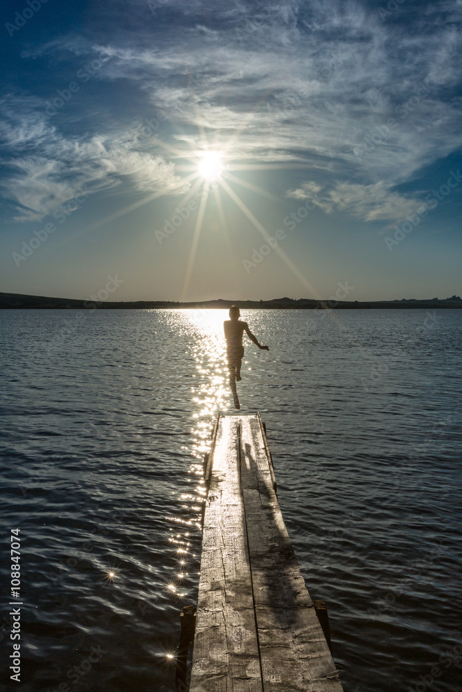 The summer mood.
The carefree childhood.
Boy jumping from the bridge into the water of the lake.
The summer mood.
The carefree childhood.
Boy jumping from the bridge into the water of the lake.