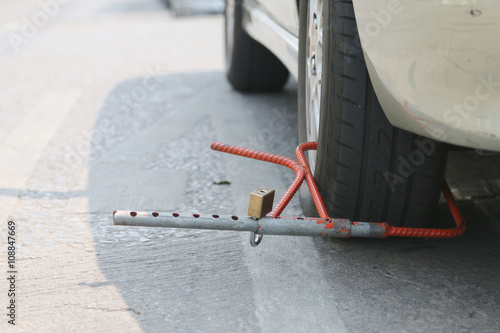 The motor vehicle is immobilised by a wheel clamp