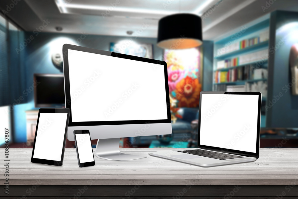 Fototapeta premium Responsive display devices on table in living room. Isolated white screen for mockup presentation