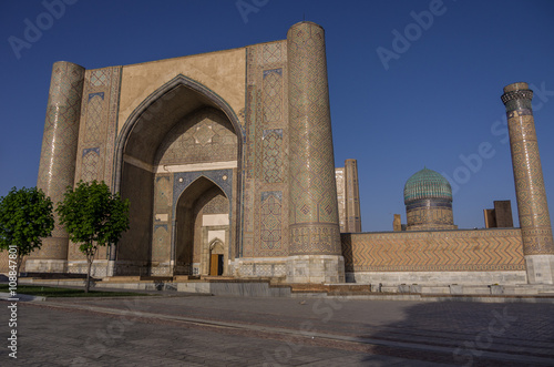 The large complex of Bibi-Khanym Mosque with the beautiful bright blue domes, rich mosaic decorations and old hieroglyphs on its walls, Samarkand, Uzbekistan.