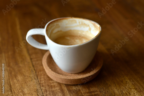 cup of espresso coffee with wooden table background