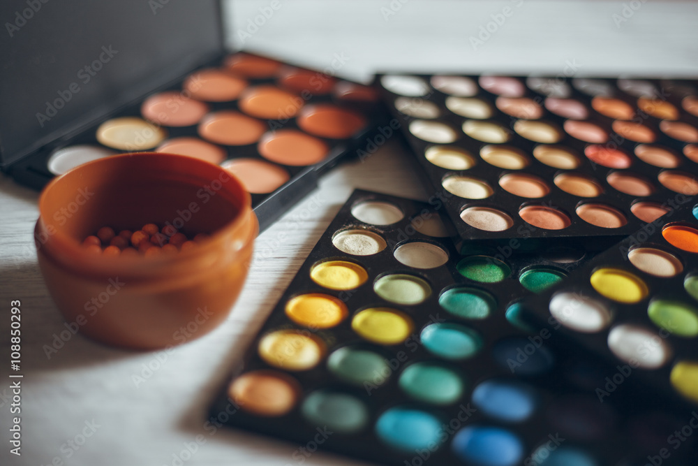 Multicolored eyeshadows on the wooden table Multicolored eyeshadows on the wooden table