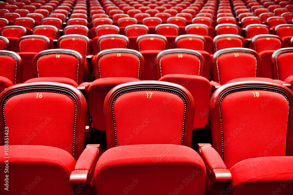 Rows with empty seats in a theater Rows with empty seats in a theater