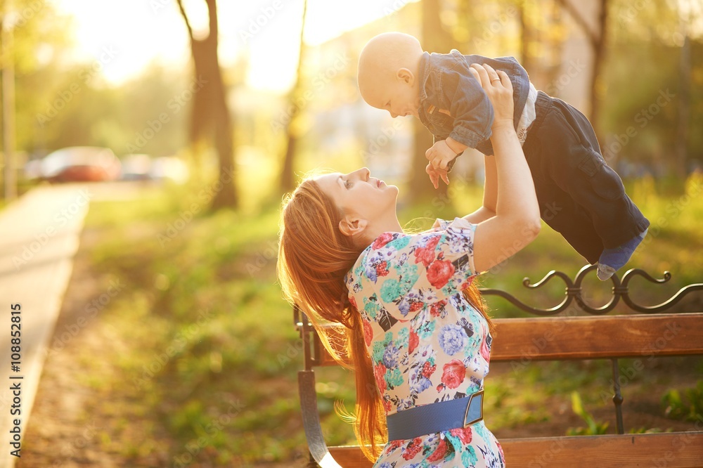 Obraz premium Beautiful young woman with baby boy