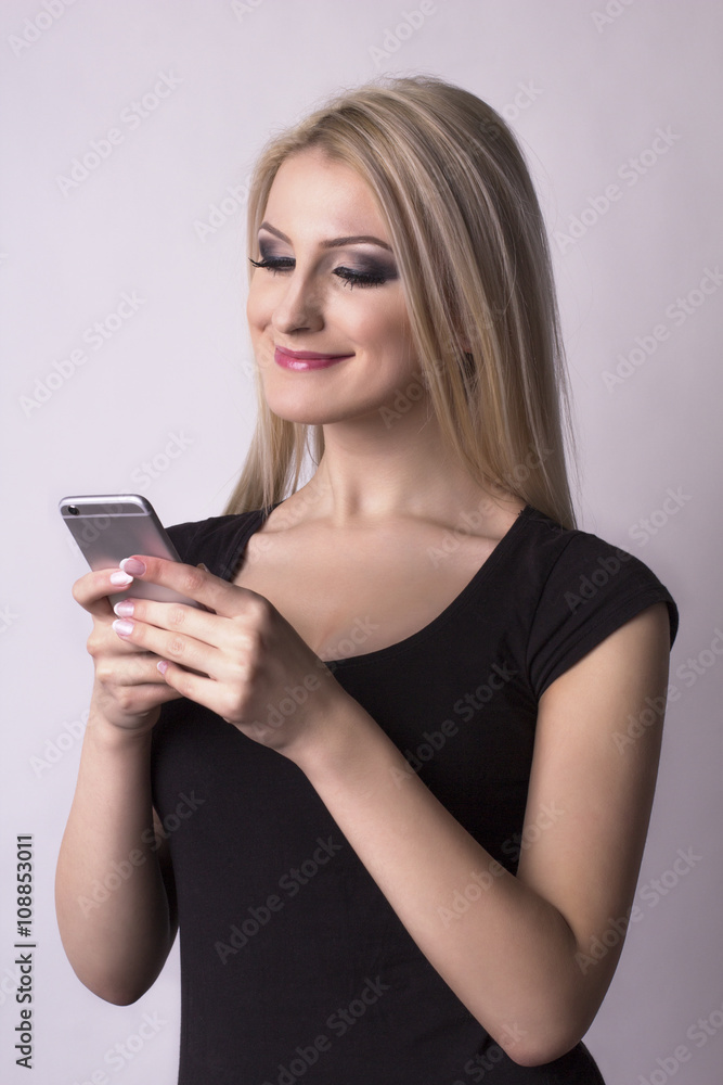 Pretty smiling woman holding mobile phone Pretty smiling woman holding mobile phone