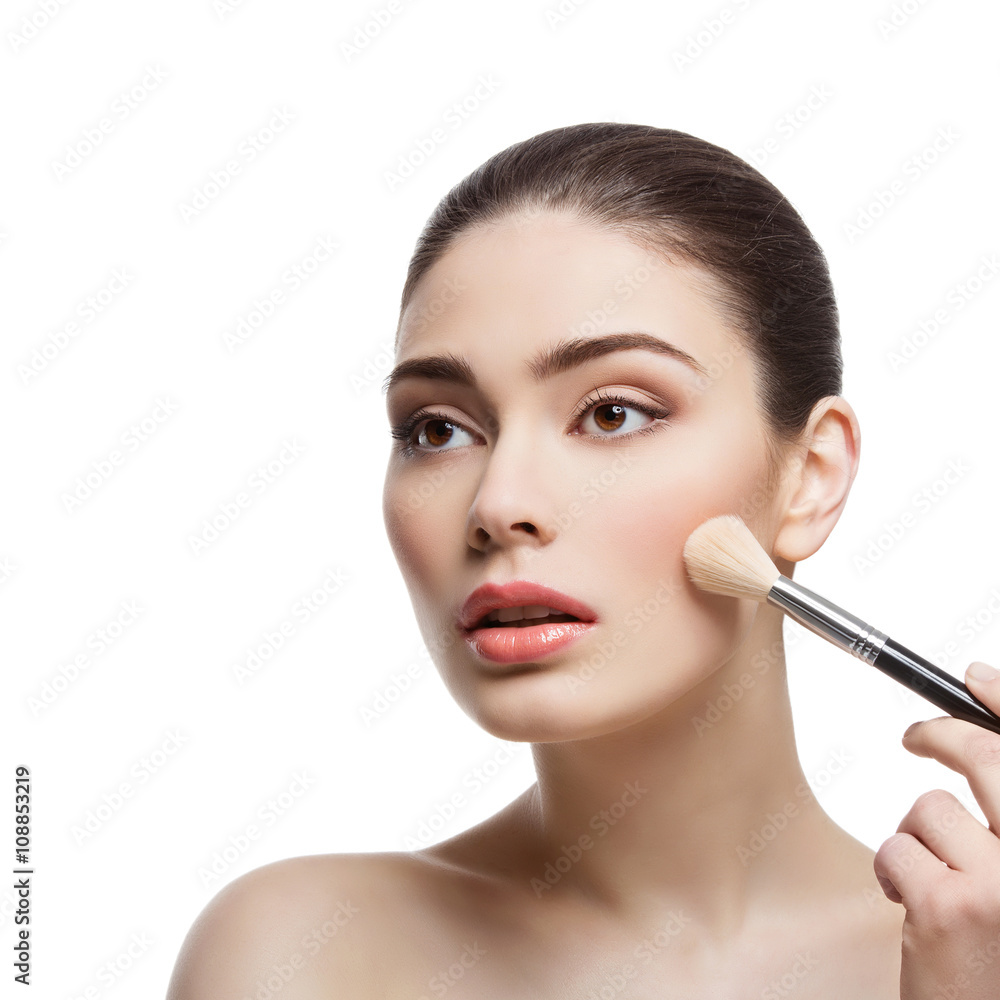 Beautiful girl applying blush with brush Beautiful girl applying blush with brush