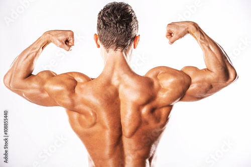 Strong Athletic Man showing muscular body and sixpack abs over white background.Muscular bodybuilder guy doing exercises with dumbbells over white background.Muscular man on white background