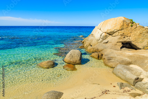 Stones in turquoise sea water on idyllic beach, Sardinia island, Italy