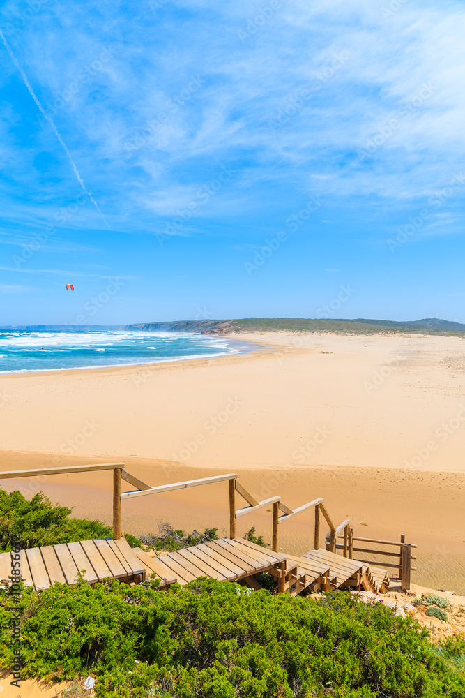 Wooden walkway to idyllic sandy Praia do Bordeira beach, Algarve region, Portugal