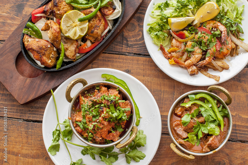 Selection of curry dishes with meat and prawns Selection of curry dishes with meat and prawns