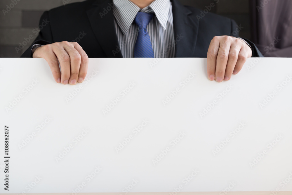 Hand of businessman showing white paper Hand of businessman showing white paper