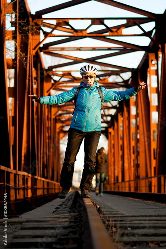 girl standing on the rails in a helmet
