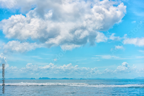 beautiful tropical blue ocean and clouds on sky with wave foam,