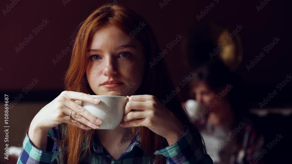 Pensive, thoughtful beautiful girl drinking coffee in cafe. Slow motion Pensive, thoughtful beautiful girl drinking coffee in cafe. Slow motion