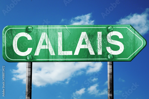 Fotografie calais road sign, vintage green with clouds background