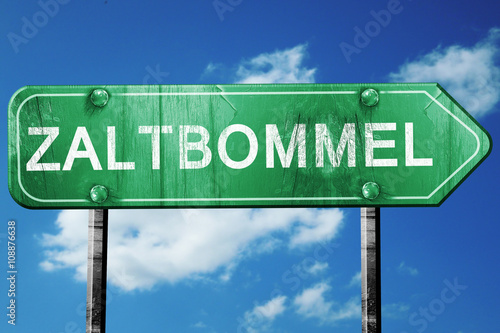 Zaltbommel road sign, vintage green with clouds background