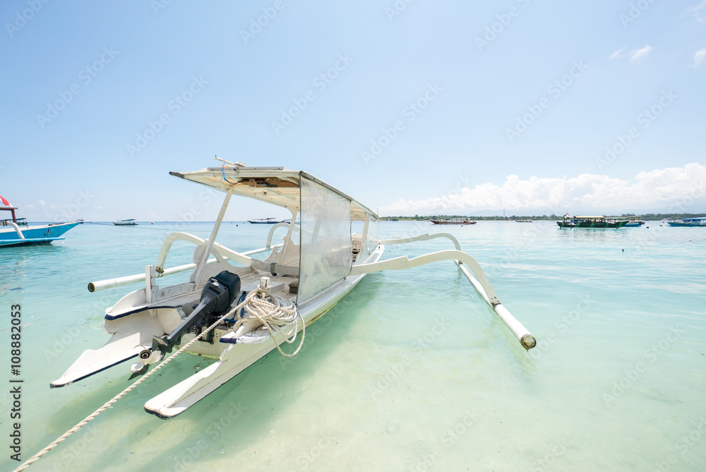 Fototapeta premium Tropical sandy beach with boats in a sea. Gili Trawangan Lombok