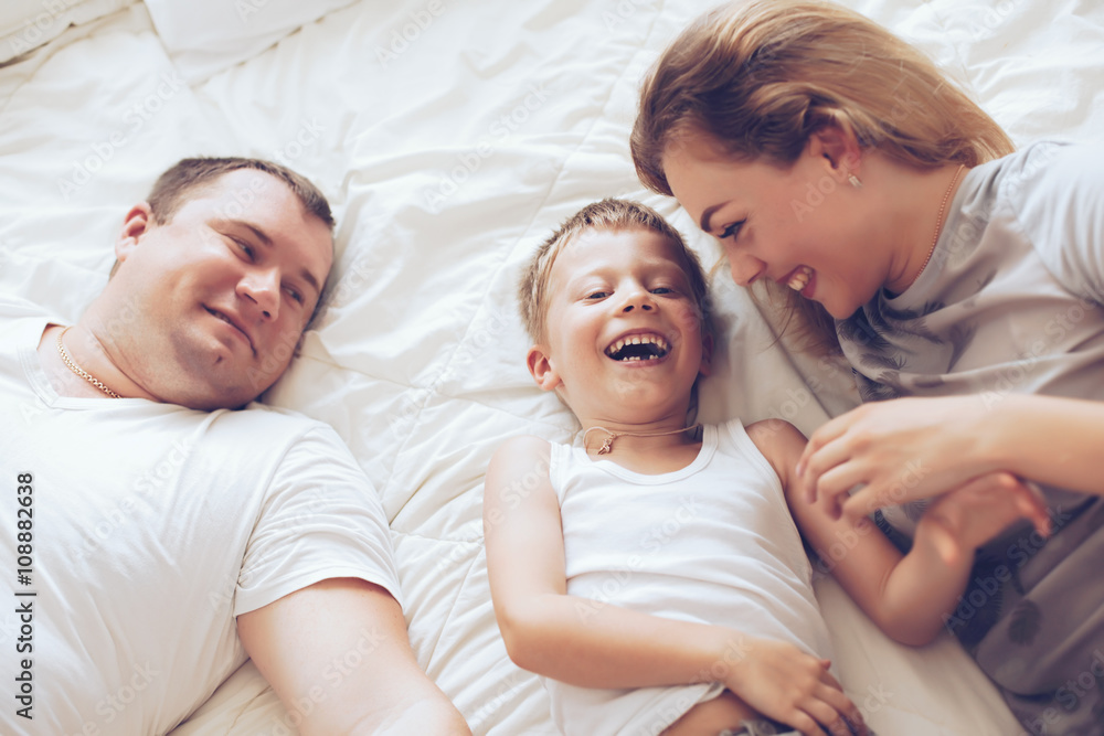 Happy family relaxing in bed Happy family relaxing in bed