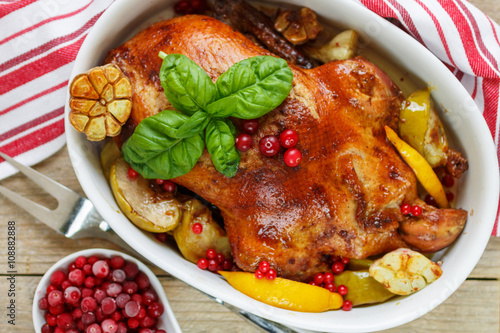 Roast duck with apples, lemon, garlic, cranberries and spices