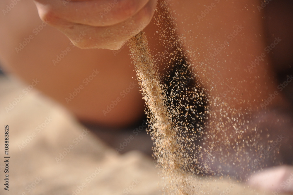 Sand flowing through hand