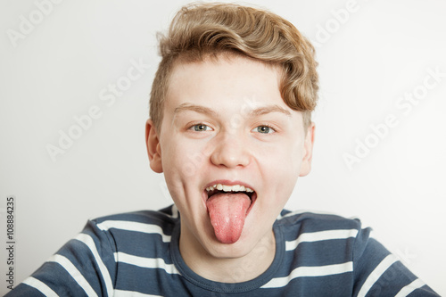 Young boy sticking out his tongue