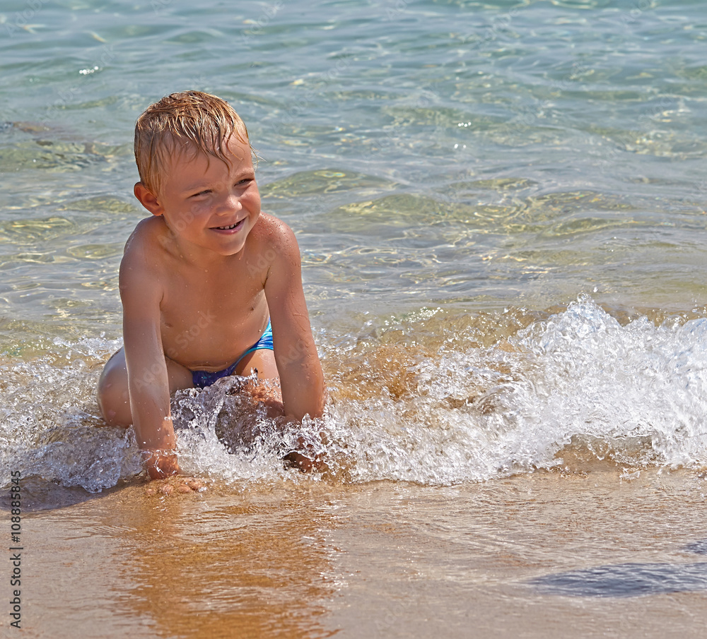happy kid playing on a beach