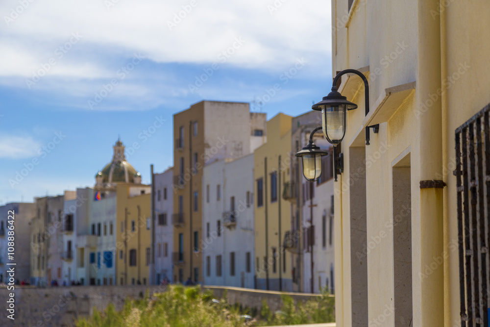 Colorful apartment buildings in Trapani Port in Sicily, Italy during clear sunny day