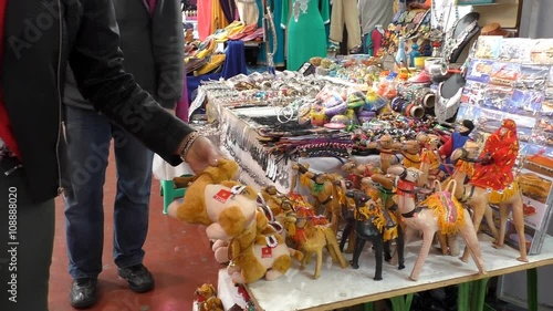 Woman tourist at Moroccan market is looking for a souvenir to buy