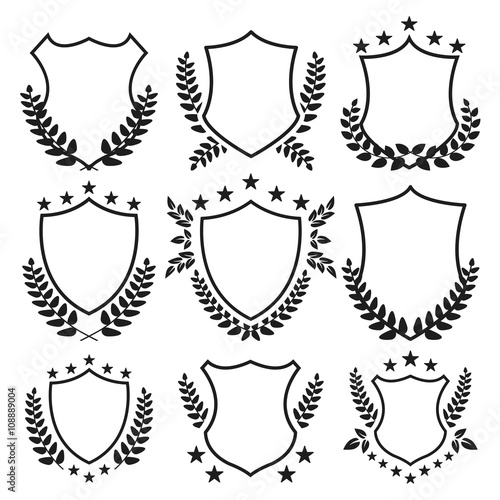 Medieval shields with stars and laurel wreaths set. Vector illustration