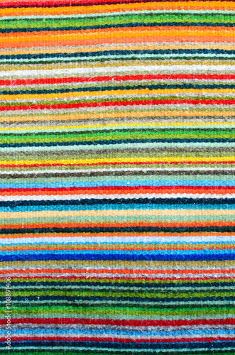 Pattern of colorful stripes - closeup of a woven carpet 
