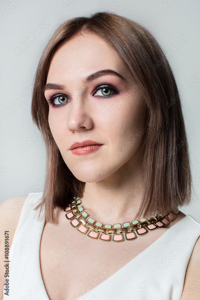 Portrait of young beautiful woman with middle length hair and smoky eyes make-up