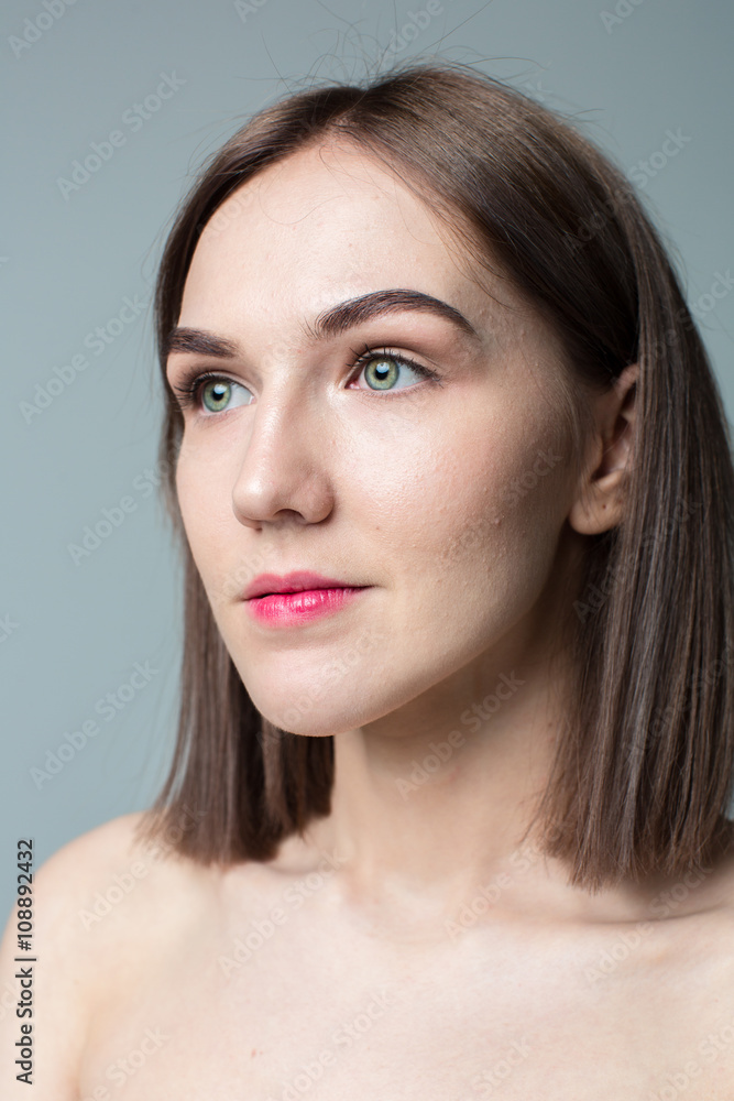 Fototapeta premium Beauty portrait of young model with middle length hair. Professional nude makeup. Green eyes.